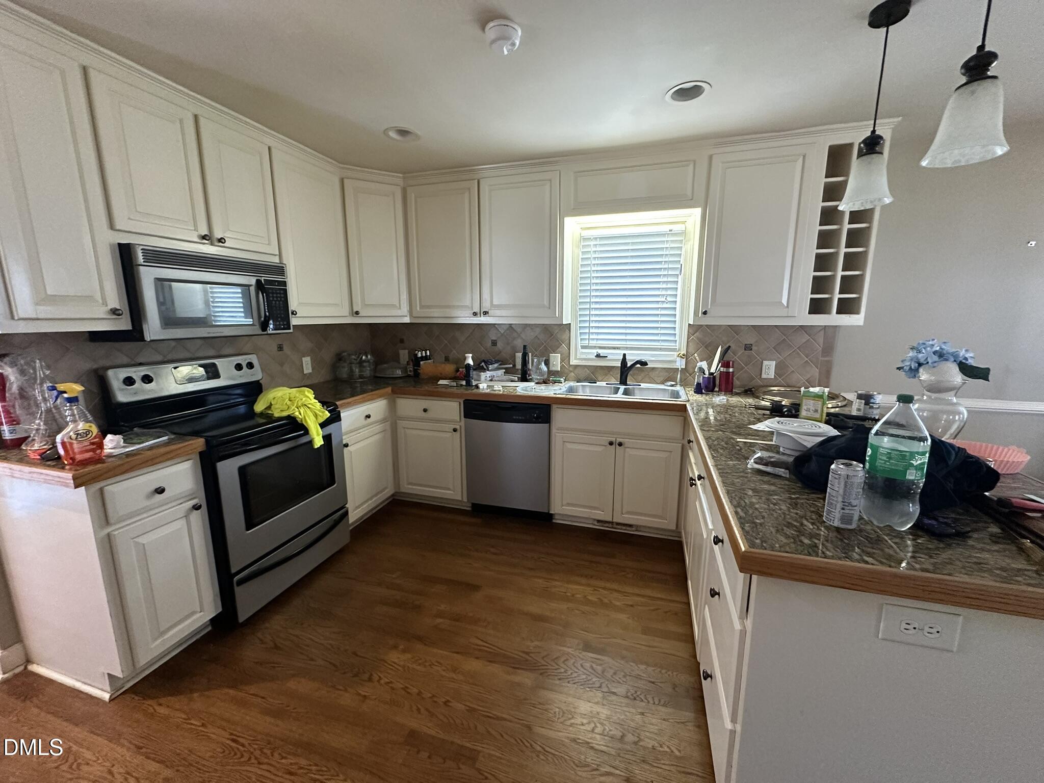7208 Eastover Drive Raleigh, NC 27603 - Photo 11 of 41 a kitchen with a sink stove top oven and microwave