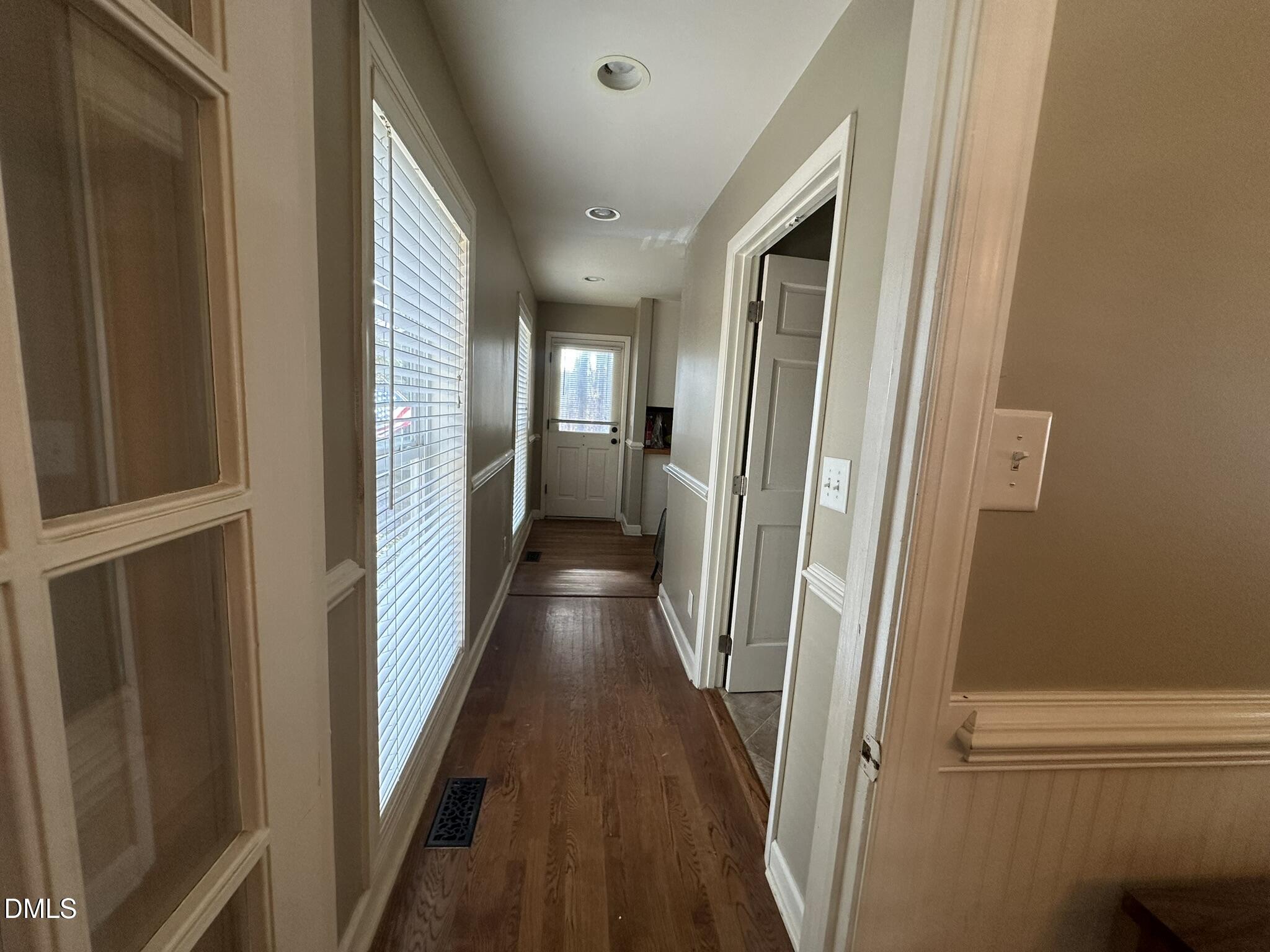 7208 Eastover Drive Raleigh, NC 27603 - Photo 15 of 41 a view of a hallway with wooden floor and staircase