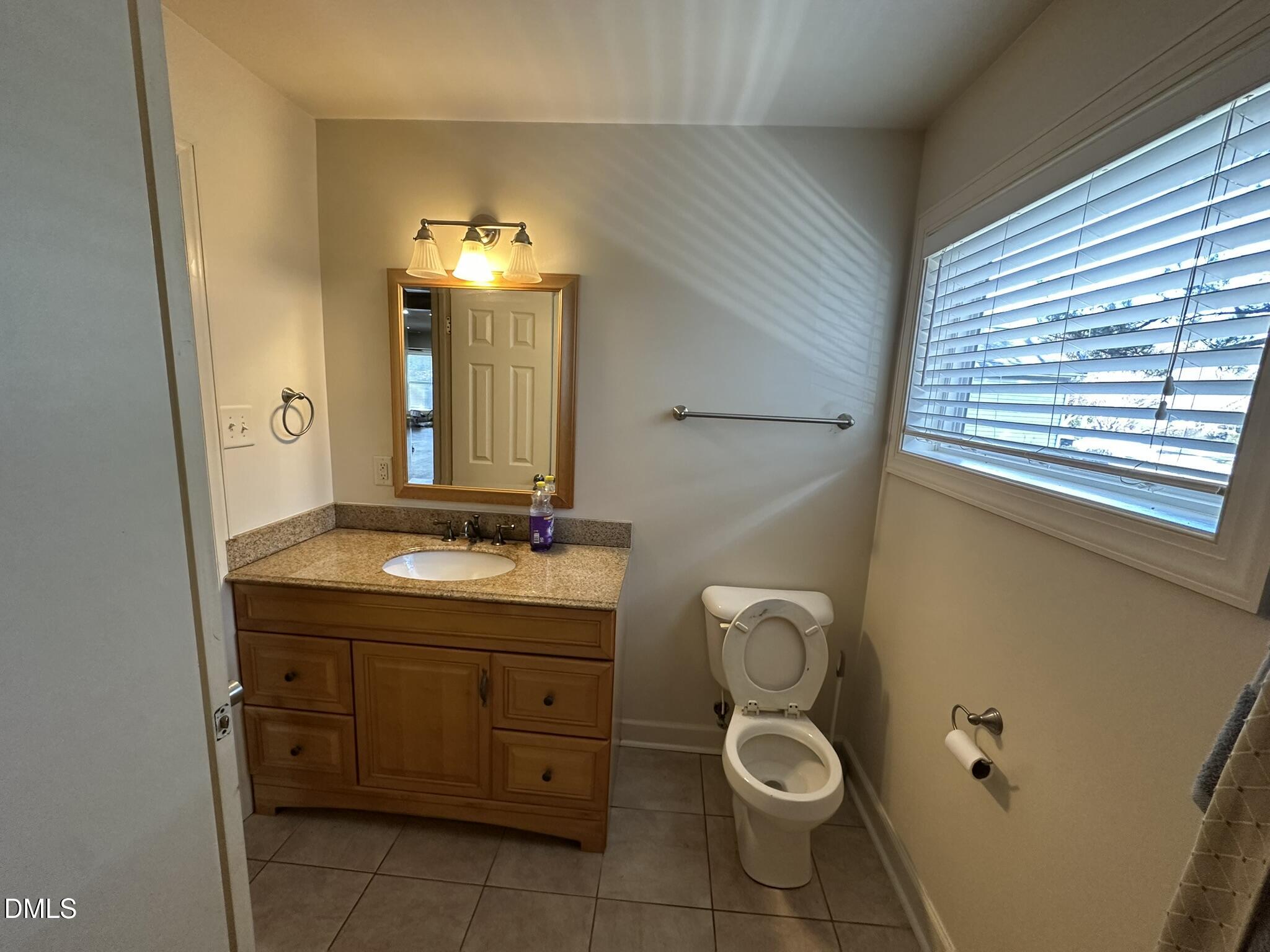 7208 Eastover Drive Raleigh, NC 27603 - Photo 17 of 41 a bathroom with a granite countertop sink toilet and mirror
