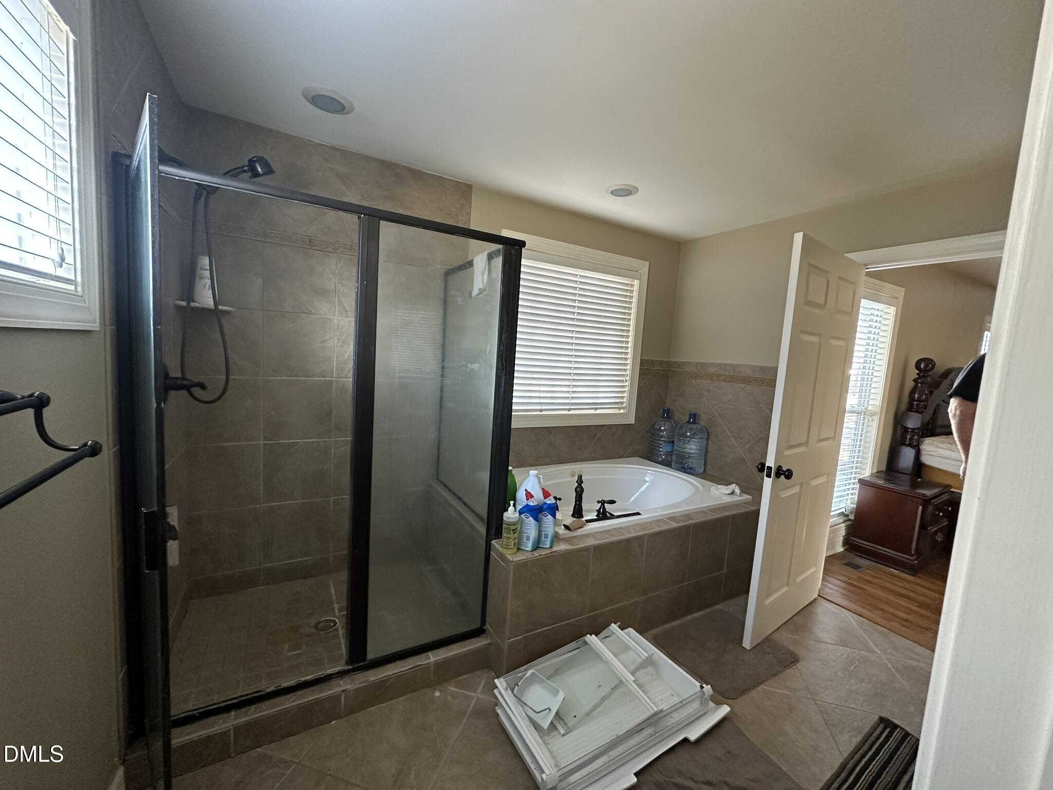 7208 Eastover Drive Raleigh, NC 27603 - Photo 27 of 41 a bathroom with a tub sink a toilet and a shower