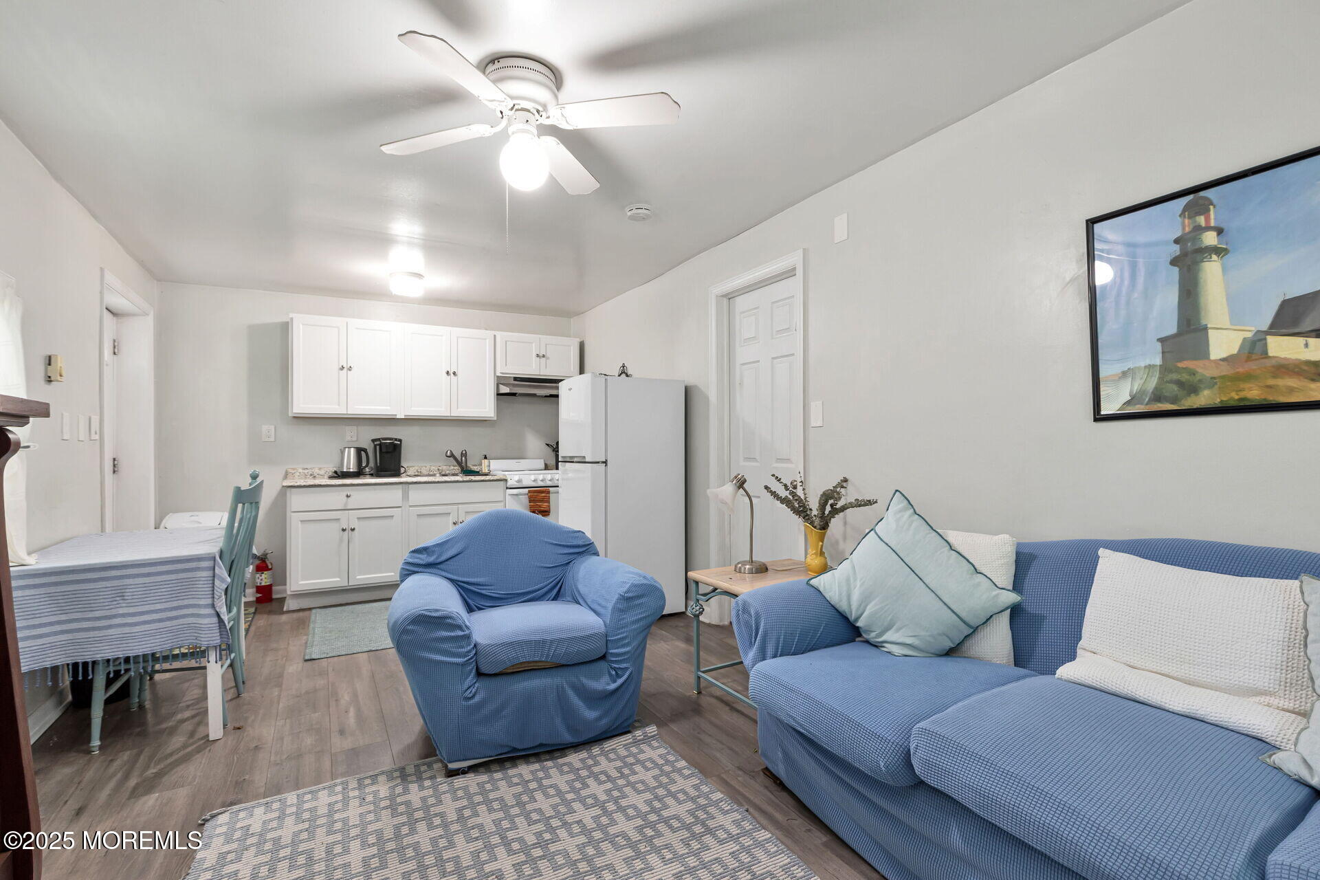 301 Norwood Avenue, Unit 3 Long Branch, NJ 07740 - Photo 7 of 17 a living room with furniture and a dining table with kitchen appliances