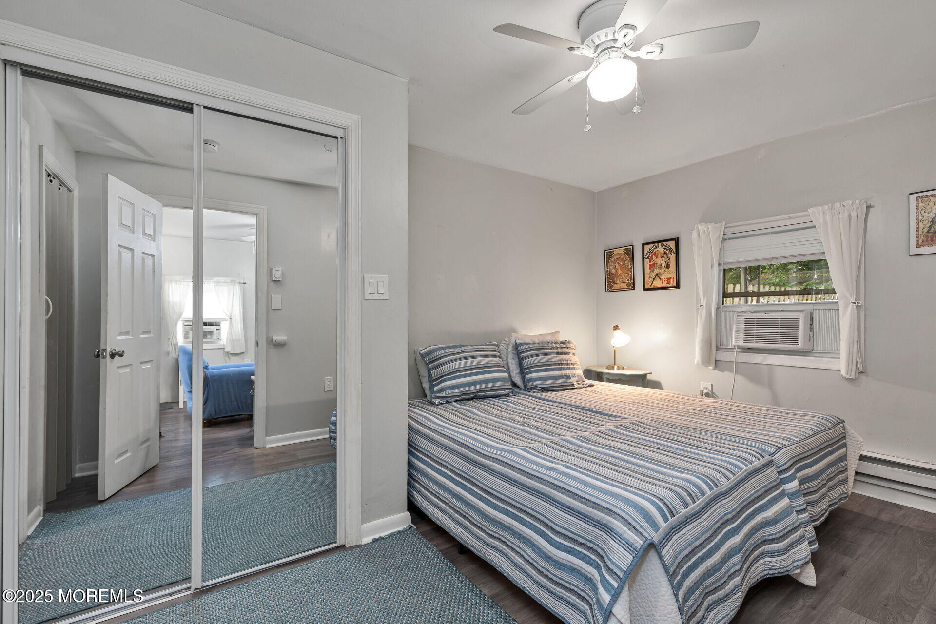 301 Norwood Avenue, Unit 3 Long Branch, NJ 07740 - Photo 8 of 17 a bedroom with a bed and a chandelier