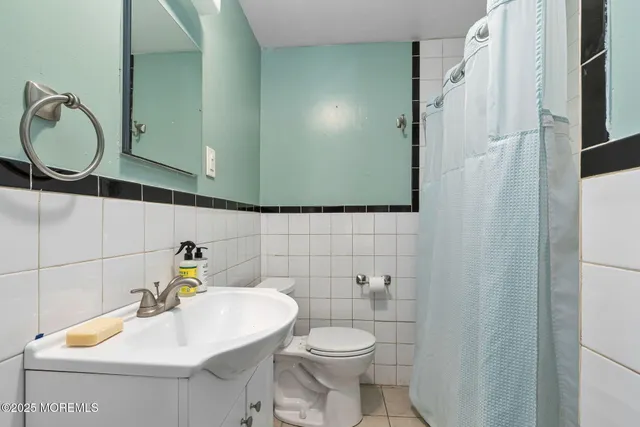 a bathroom with a sink mirror and toilet