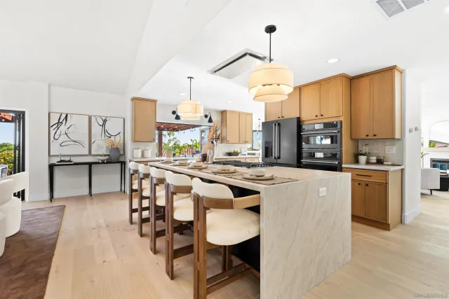 a view of a counter top dining table and chairs