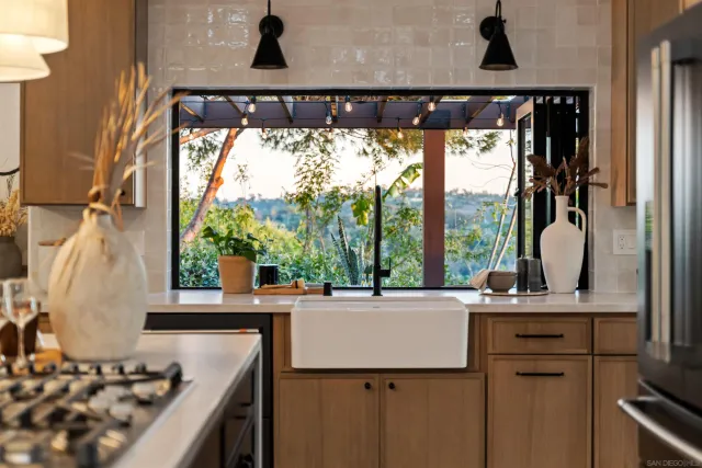 a living room with furniture a window and a kitchen view