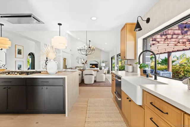 a living room with furniture a fireplace and a large window