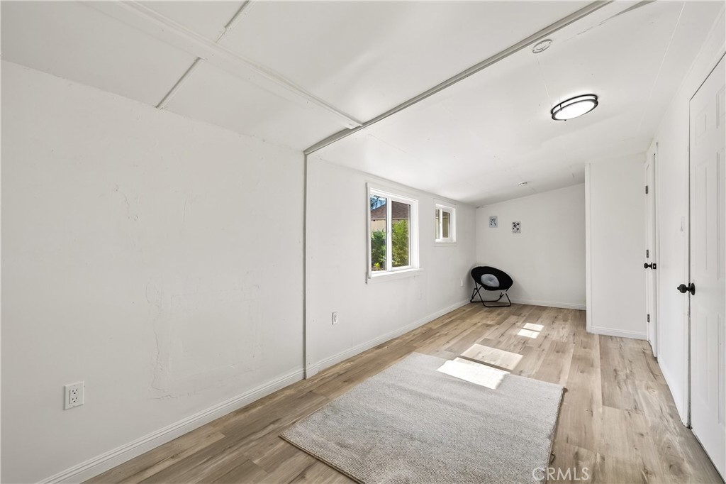 17653 Raley Avenue Lake Elsinore, CA 92530 - Photo 11 of 29 a view of a room with wooden floor and a window