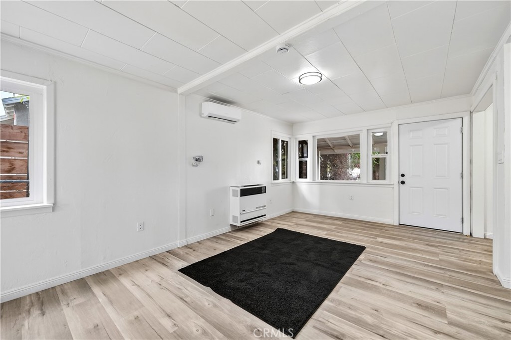 17653 Raley Avenue Lake Elsinore, CA 92530 - Photo 13 of 29 wooden floor in an empty room with a window
