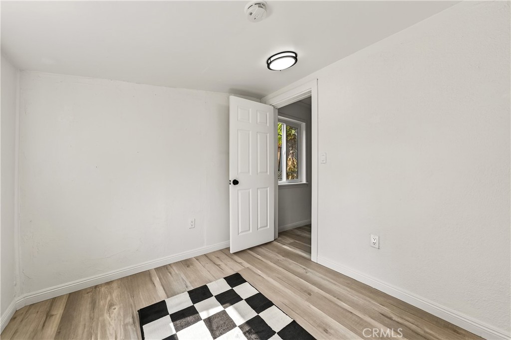 17653 Raley Avenue Lake Elsinore, CA 92530 - Photo 14 of 29 a view of a closet area with wooden floor