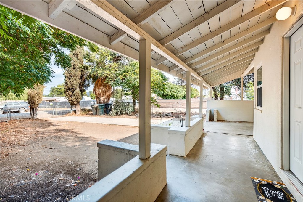 17653 Raley Avenue Lake Elsinore, CA 92530 - Photo 17 of 29 a view of a porch with furniture and a backyard