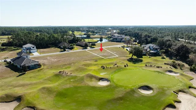 a view of a swimming pool with a yard and ocean view