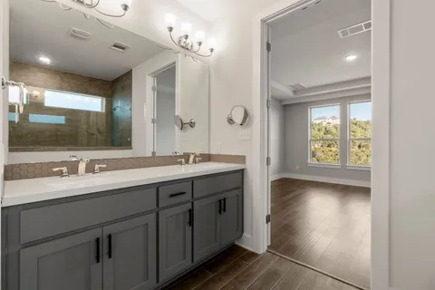 a bathroom with a double vanity sink and a mirror