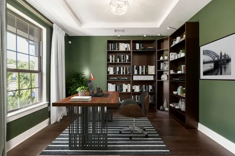 a living room with furniture a rug and a bookshelf