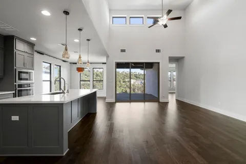 a kitchen with stainless steel appliances granite countertop a refrigerator a sink and a stove