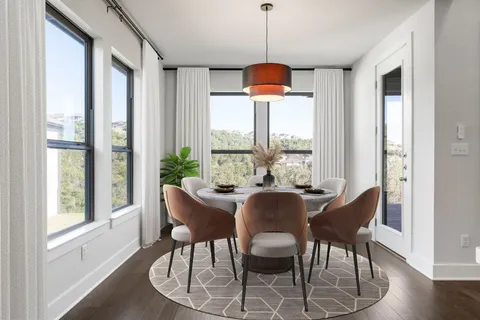 a view of a dining room with furniture window and wooden floor