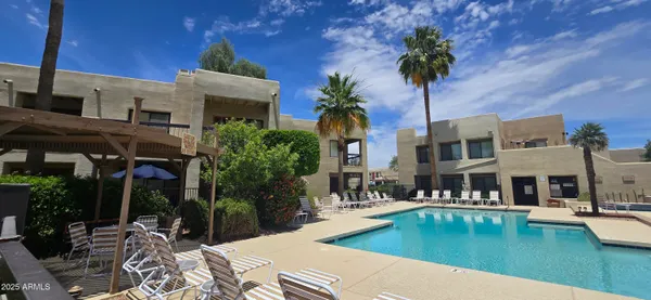a view of a patio with swimming pool table and chairs