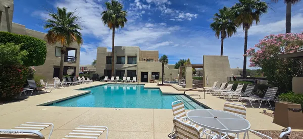 a swimming pool with outdoor seating and yard