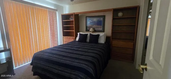 a bedroom with a bed and a window