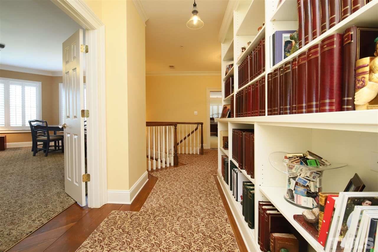207 Oval Park Place Chapel Hill, NC 27517 - Photo 16 of 30 The hallway on the second floor features custom bookshelves just outside of the media room.