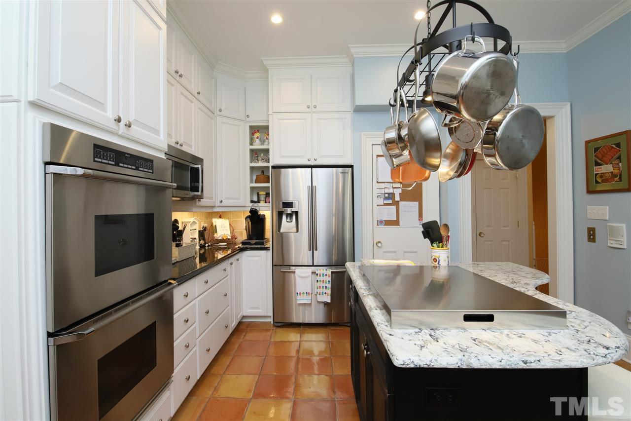 207 Oval Park Place Chapel Hill, NC 27517 - Photo 4 of 30 A view from the kitchen towards the first floor hallway and the adjacent living room.