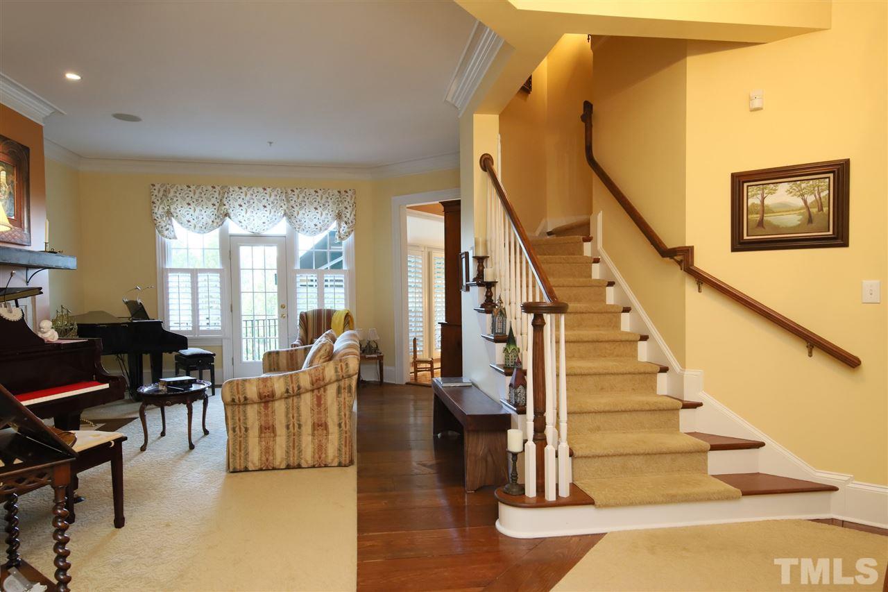 207 Oval Park Place Chapel Hill, NC 27517 - Photo 7 of 30 A gracious staircase leads from the foyer and living room to the second level.
