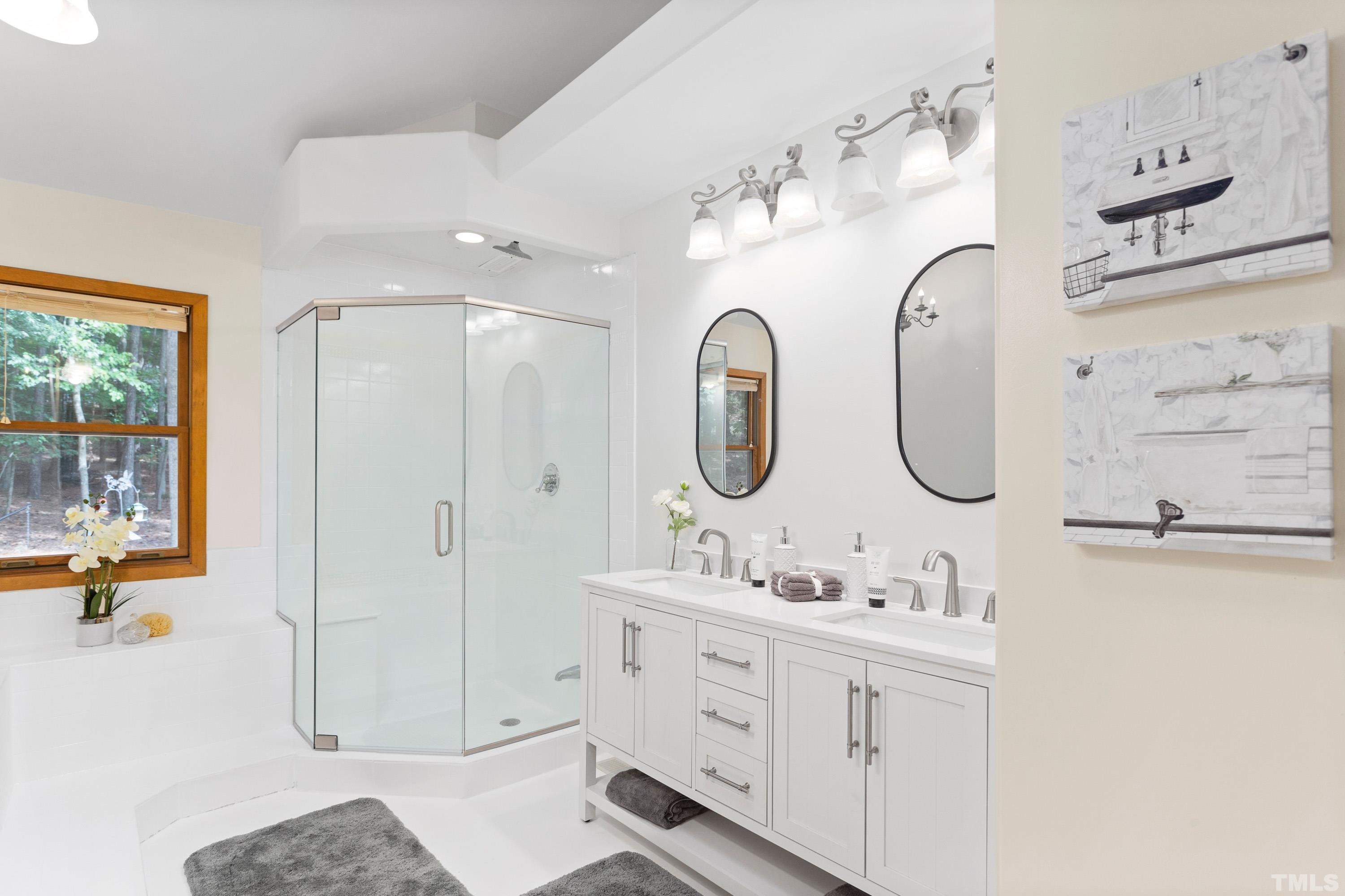 2600 Ferrand Drive Durham, NC 27705 - Photo 17 of 67 a bathroom with a double vanity sink mirror and bathtub