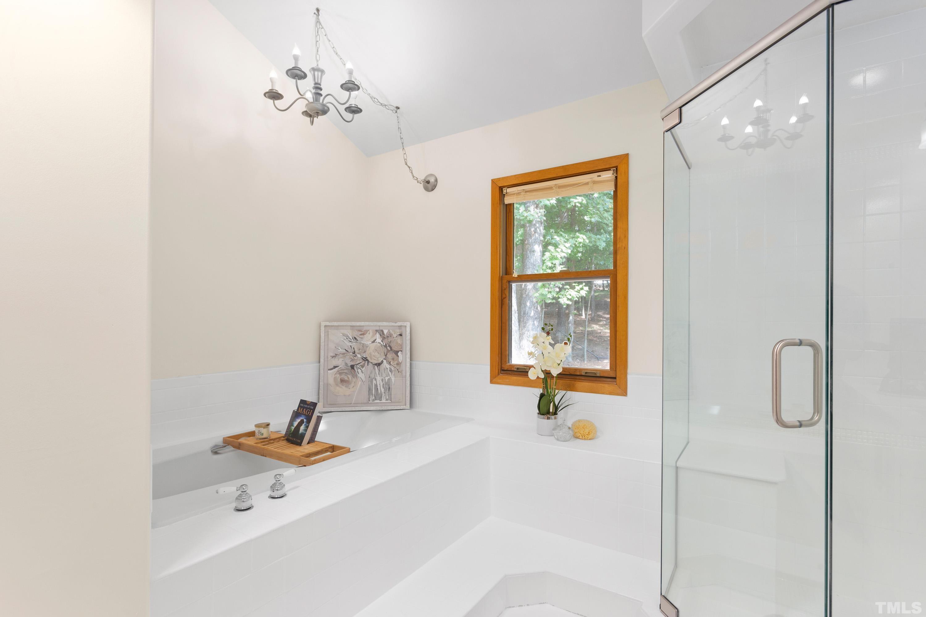 2600 Ferrand Drive Durham, NC 27705 - Photo 18 of 67 a bathroom with a tub a sink and a window