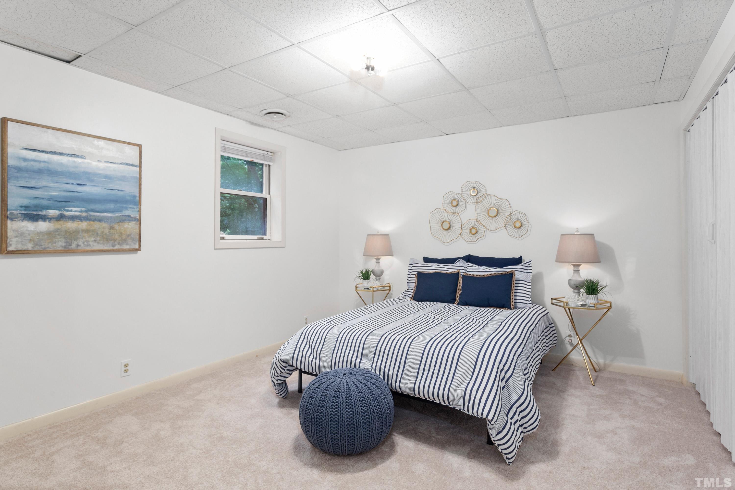 2600 Ferrand Drive Durham, NC 27705 - Photo 24 of 67 a bedroom with a bed and lamp