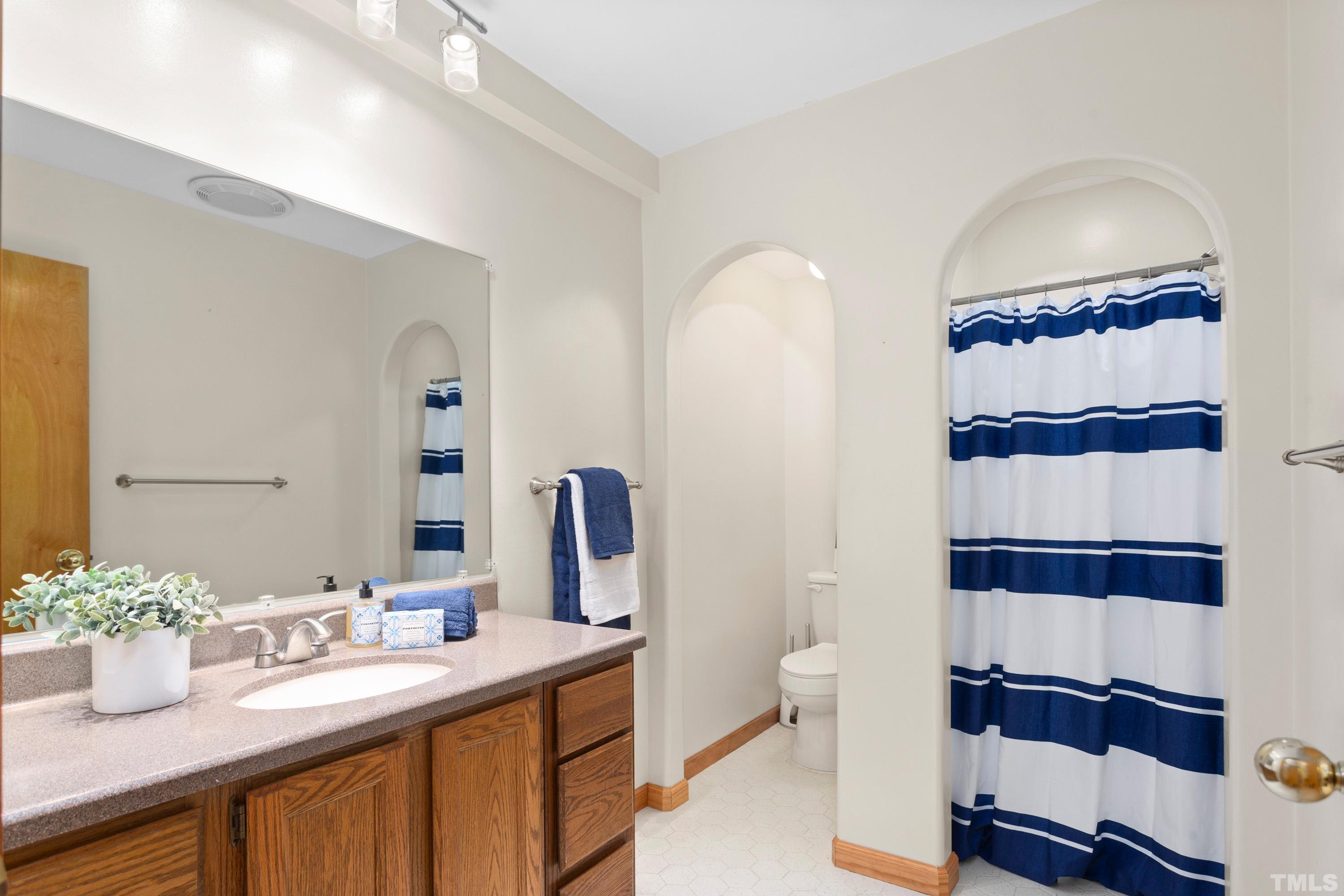 2600 Ferrand Drive Durham, NC 27705 - Photo 25 of 67 a bathroom with a sink a toilet and shower