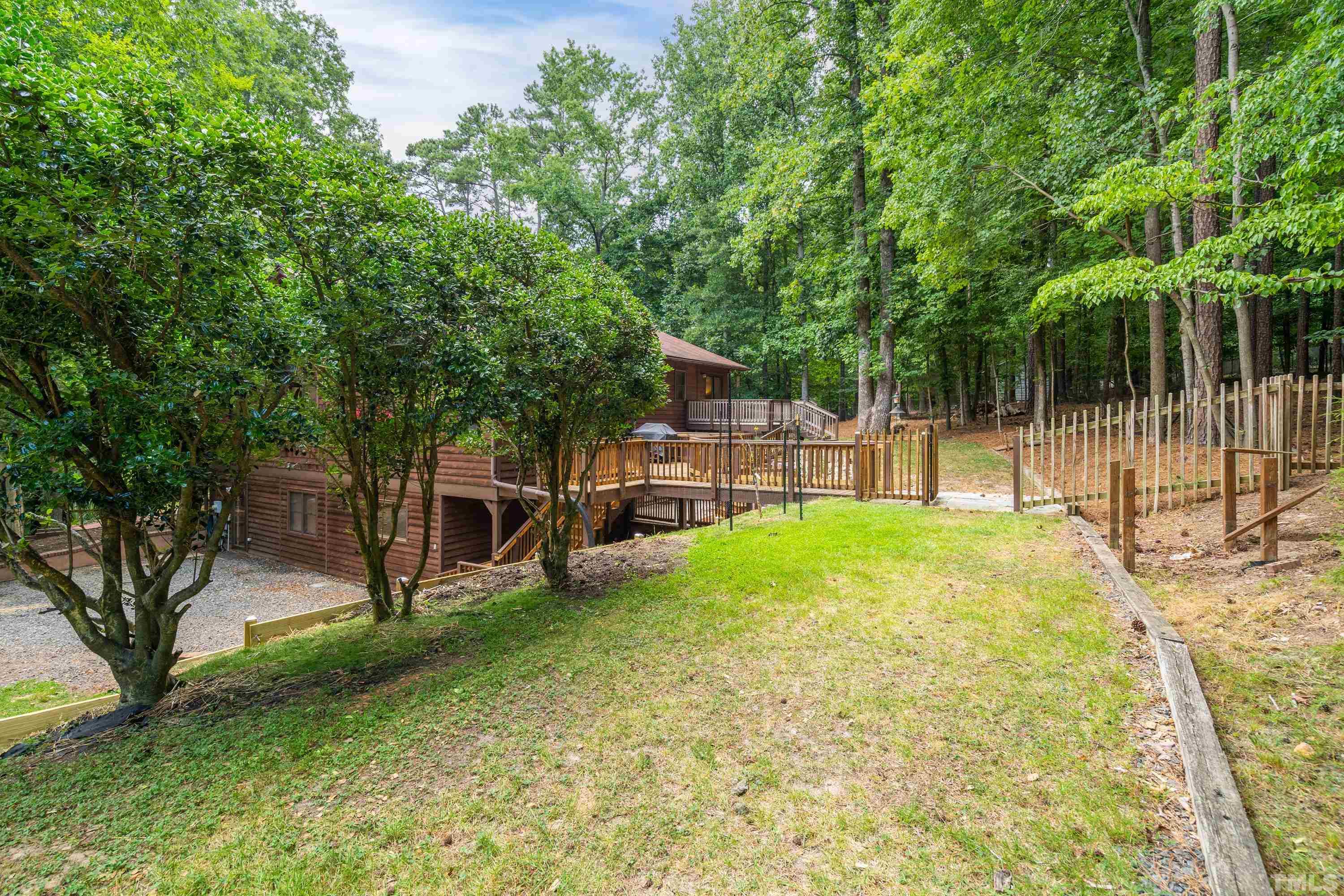 2600 Ferrand Drive Durham, NC 27705 - Photo 64 of 67 a view of a backyard with swings and slides