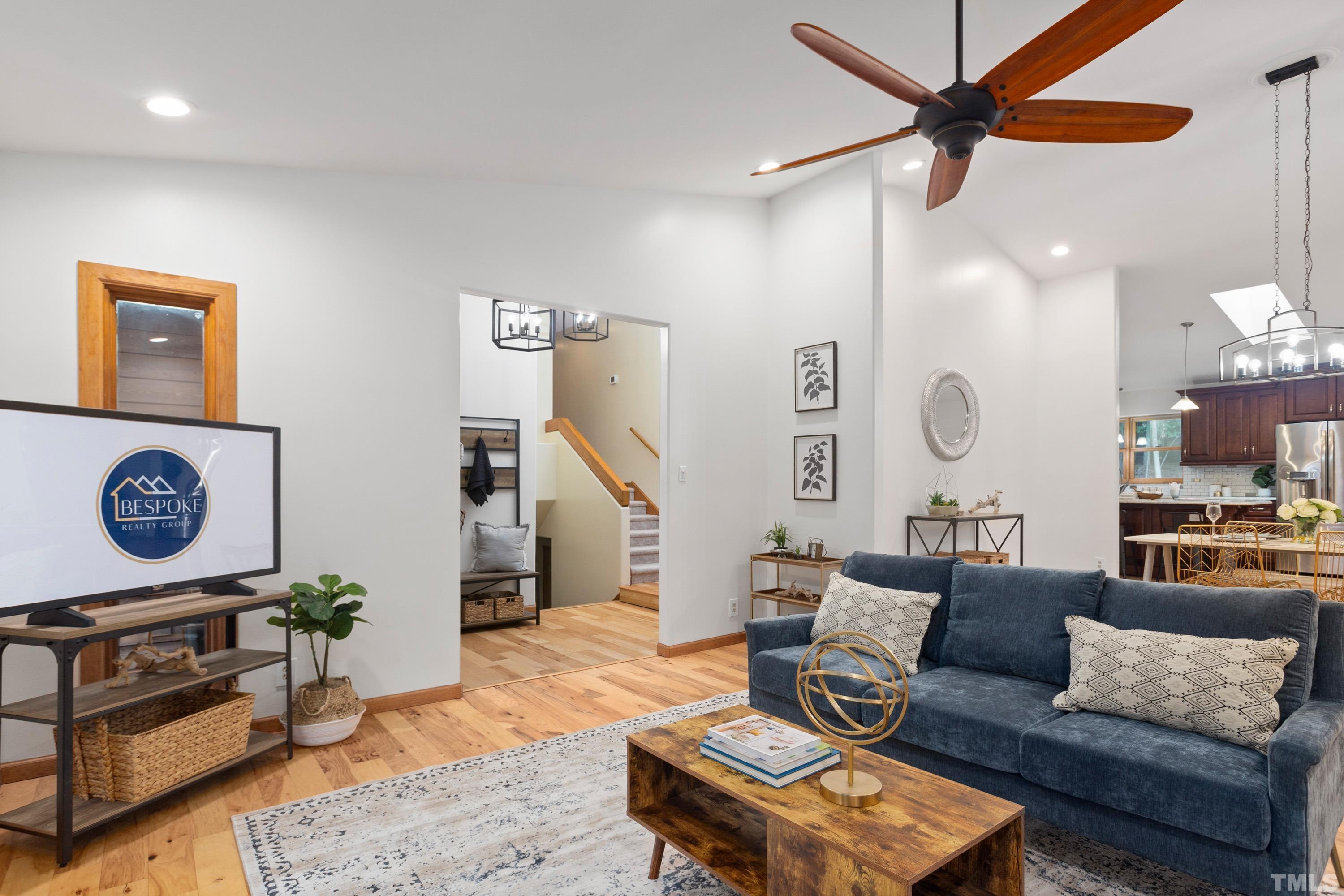 2600 Ferrand Drive Durham, NC 27705 - Photo 8 of 67 a living room with furniture a rug and a wall painting