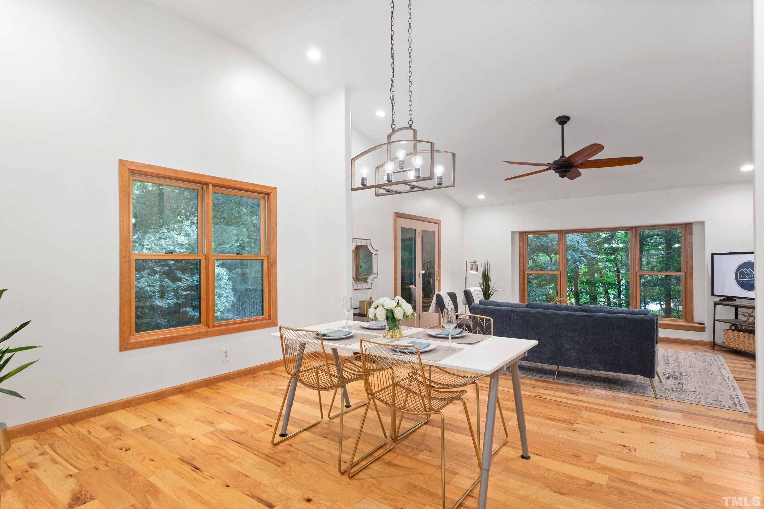2600 Ferrand Drive Durham, NC 27705 - Photo 9 of 67 a dining room with wooden floor a chandelier a wooden table and chairs