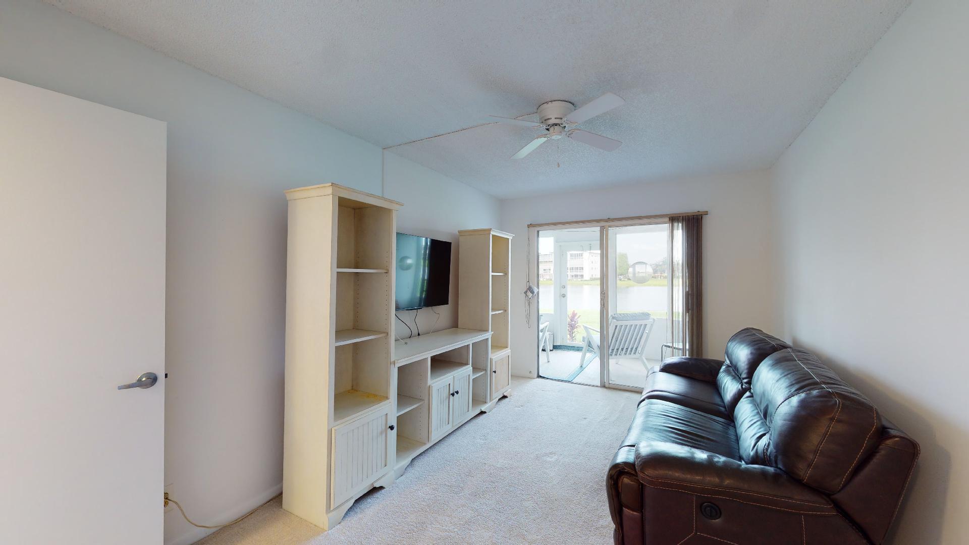 1014 Exeter Boca Raton, FL 33434 - Photo 14 of 31 a living room with furniture and a flat screen tv