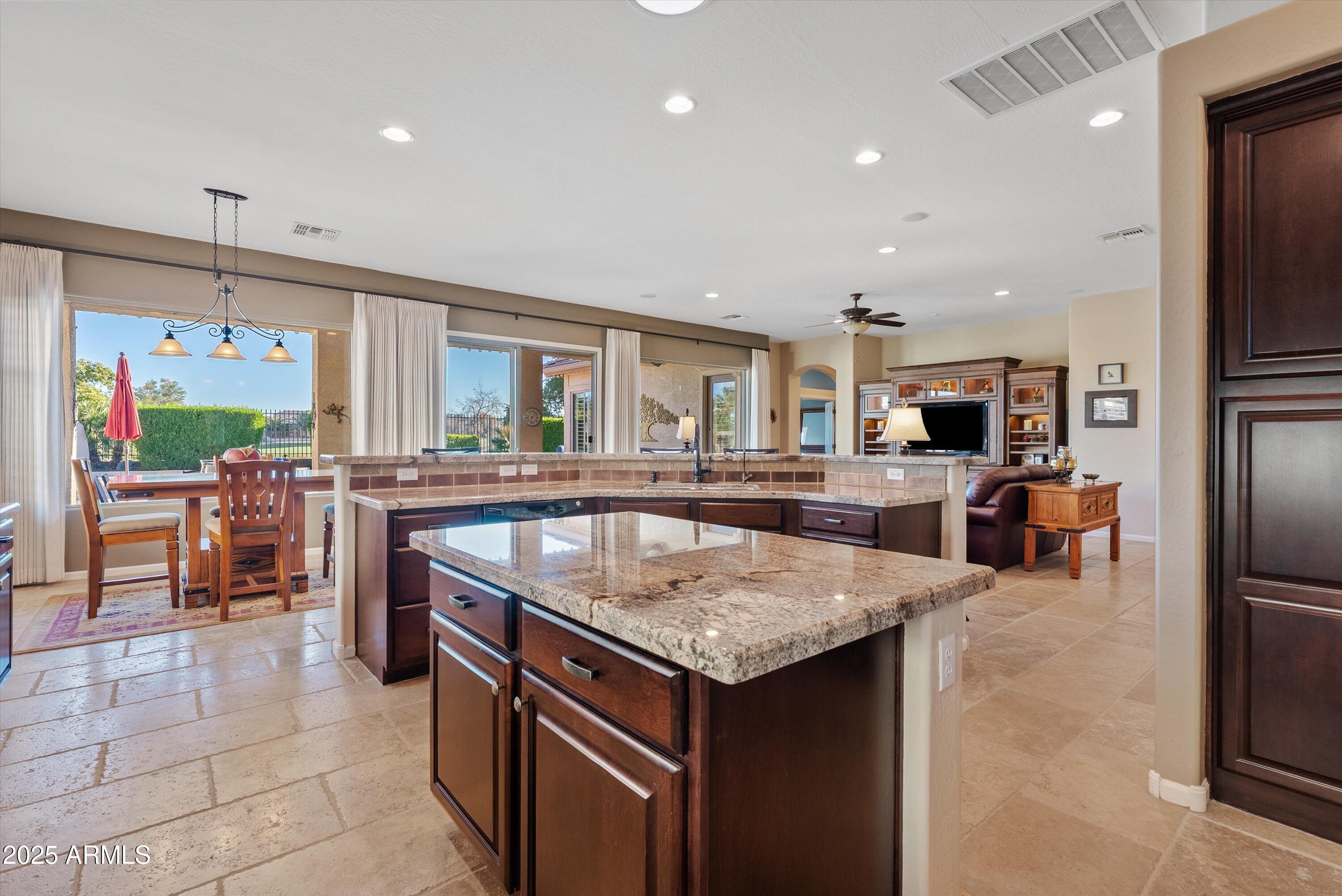 6805 Rachael Way Gilbert, AZ 85298 - Photo 12 of 50 a kitchen with stainless steel appliances granite countertop a sink and a refrigerator