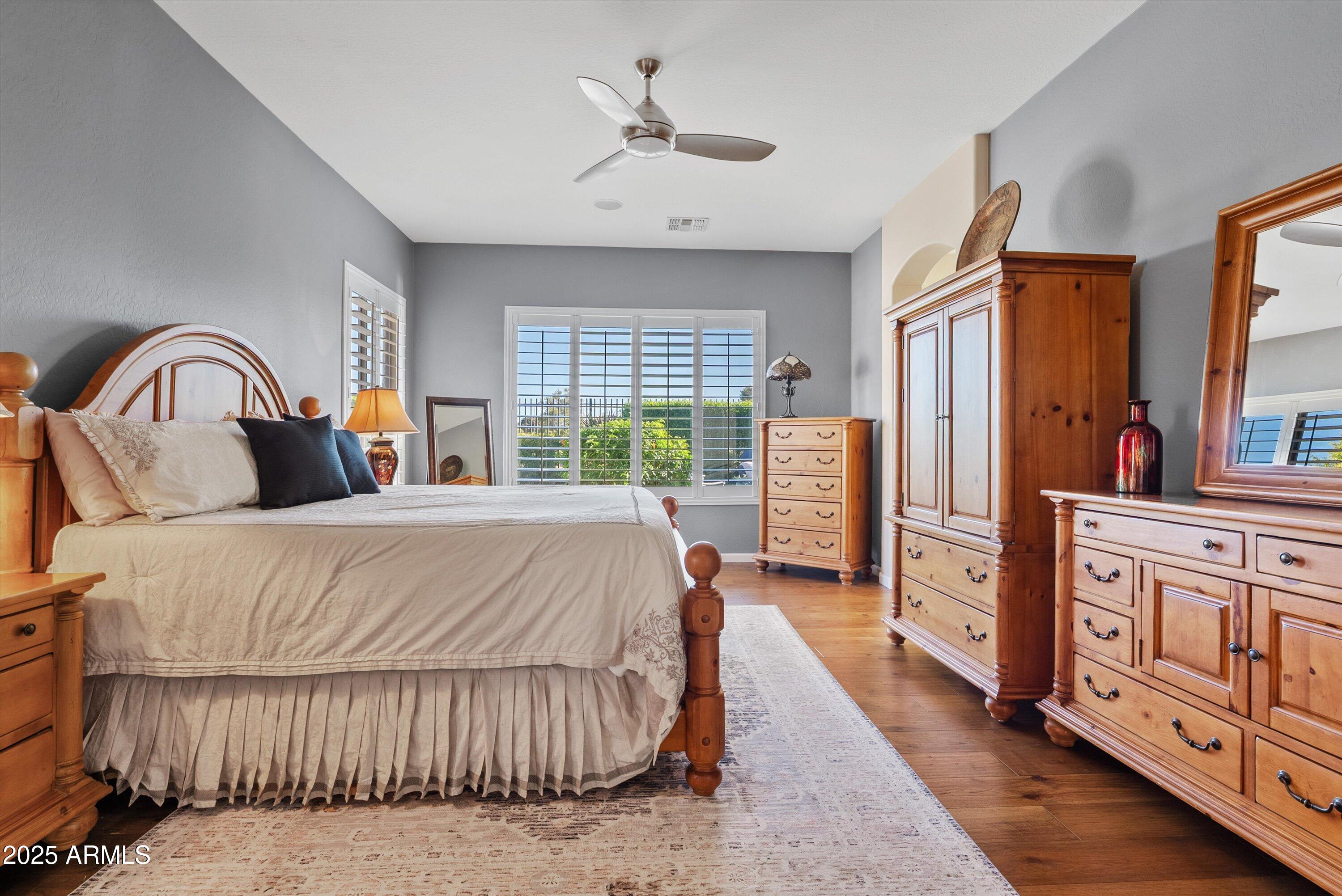 6805 Rachael Way Gilbert, AZ 85298 - Photo 19 of 50 a bedroom with a large bed and a dresser