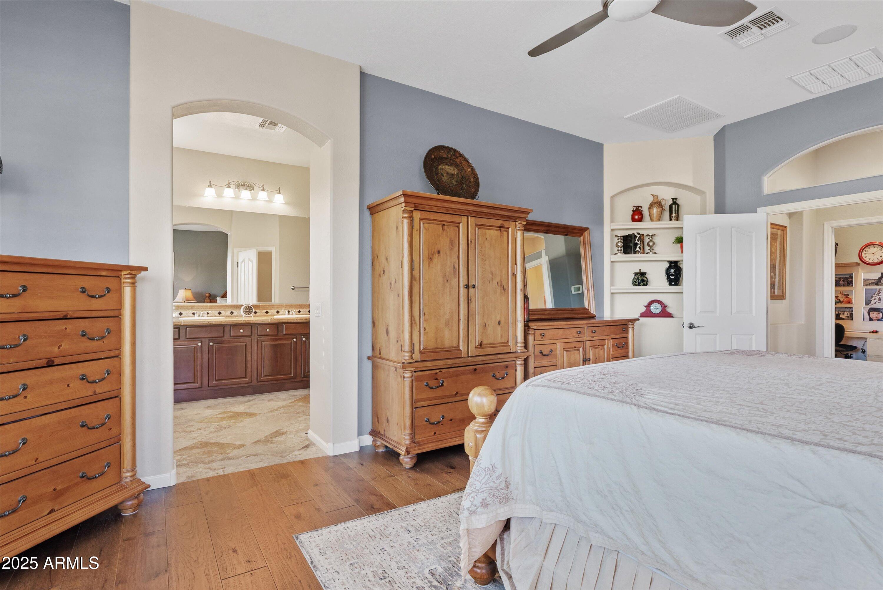 6805 Rachael Way Gilbert, AZ 85298 - Photo 20 of 50 a spacious bedroom with a bed and a view of bathroom