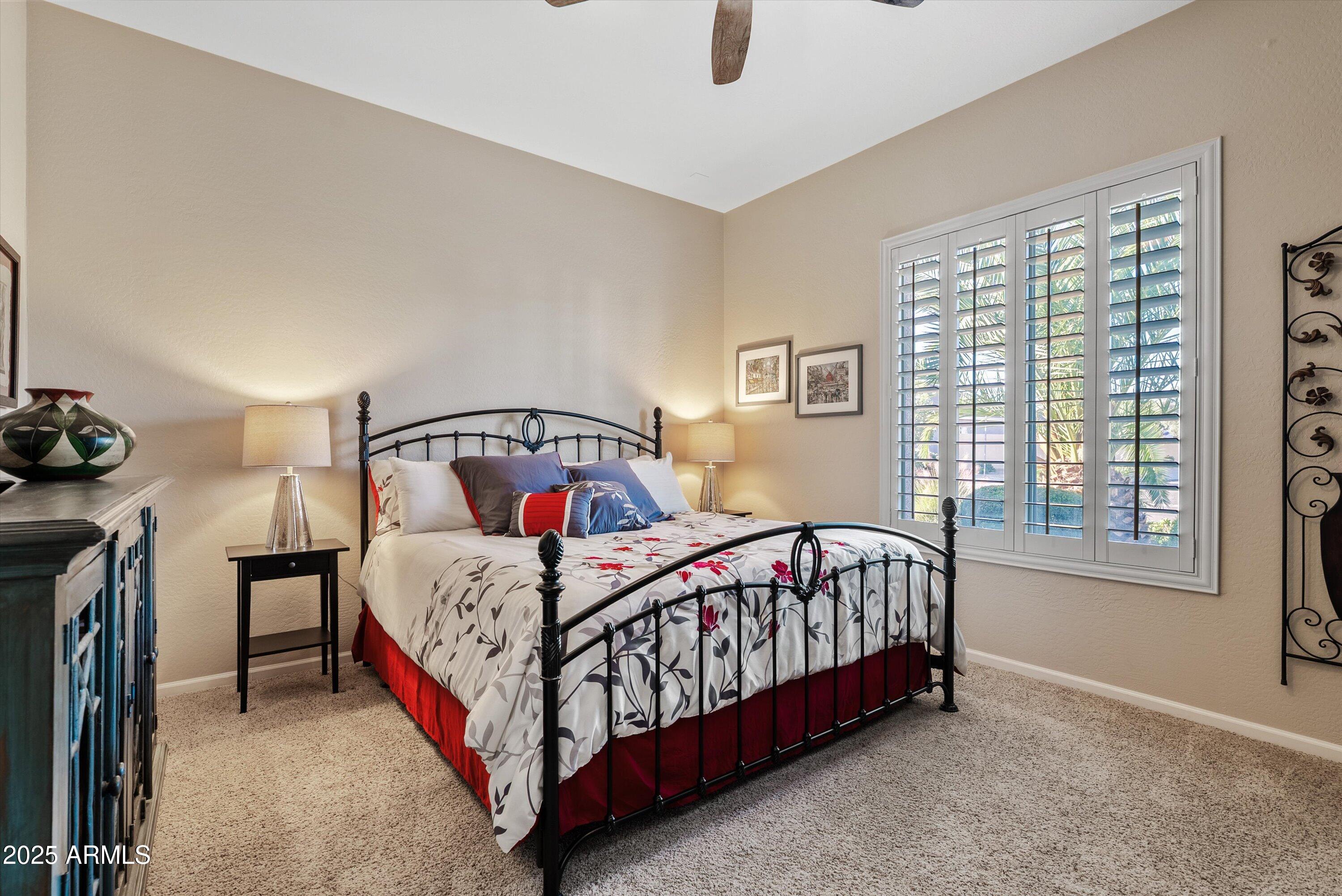 6805 Rachael Way Gilbert, AZ 85298 - Photo 27 of 50 a bed sitting in a bedroom next to a window