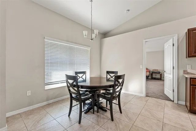 a view of a dining room with furniture and window