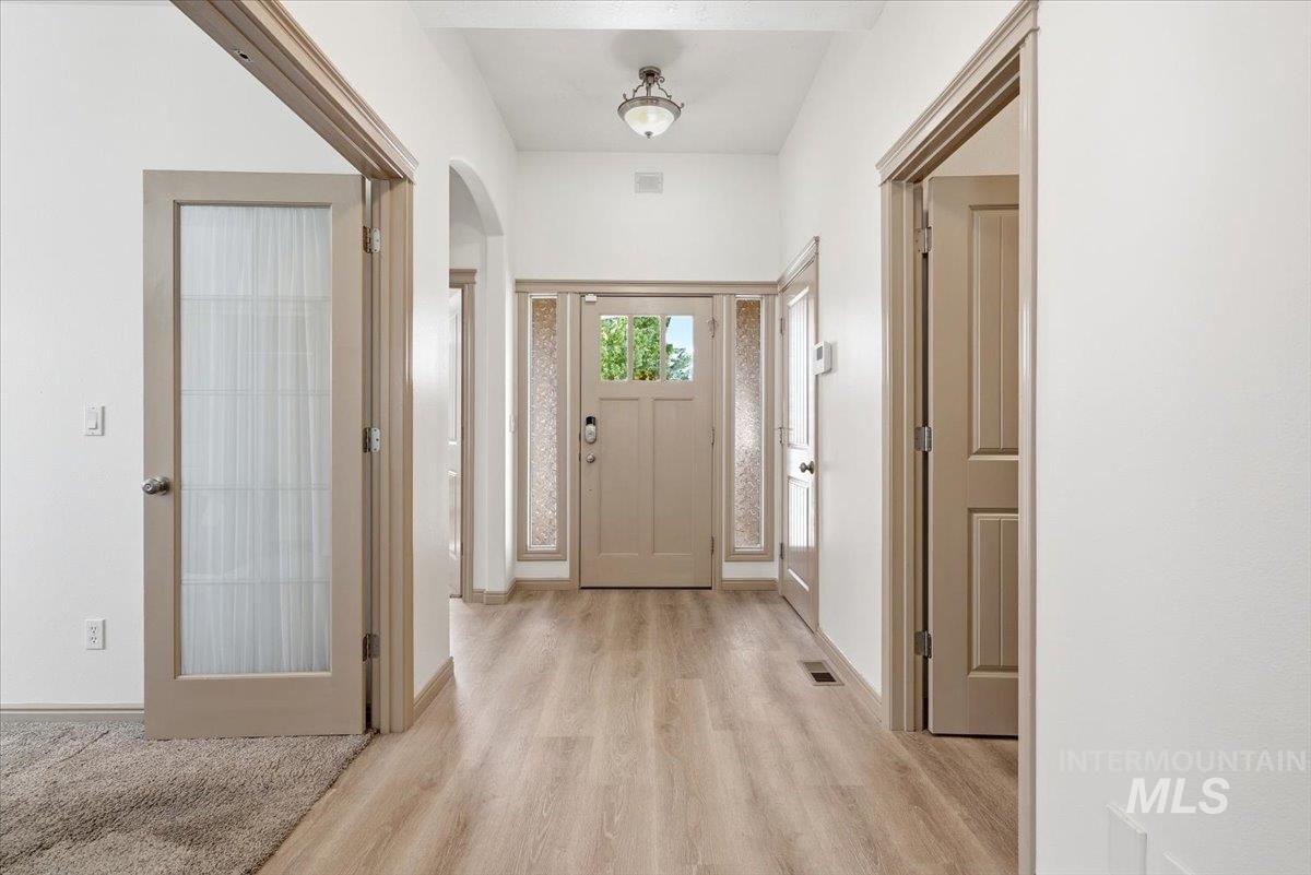 1183 North Buffalo Way Middleton, ID 83644 - Photo 33 of 47 Foyer featuring wood-finish flooring, white walls, and light beige trim, doors, and baseboards