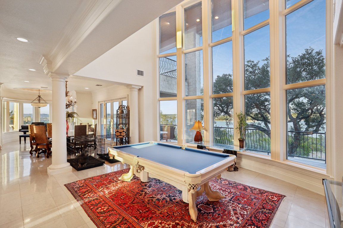 14701 Hornsby Hill Road Austin, TX 78734 - Photo 11 of 40 a living room with furniture a rug and a large window
