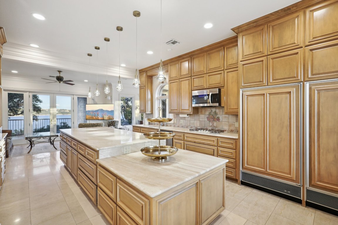 14701 Hornsby Hill Road Austin, TX 78734 - Photo 13 of 40 a kitchen with stainless steel appliances granite countertop a sink a stove and a refrigerator