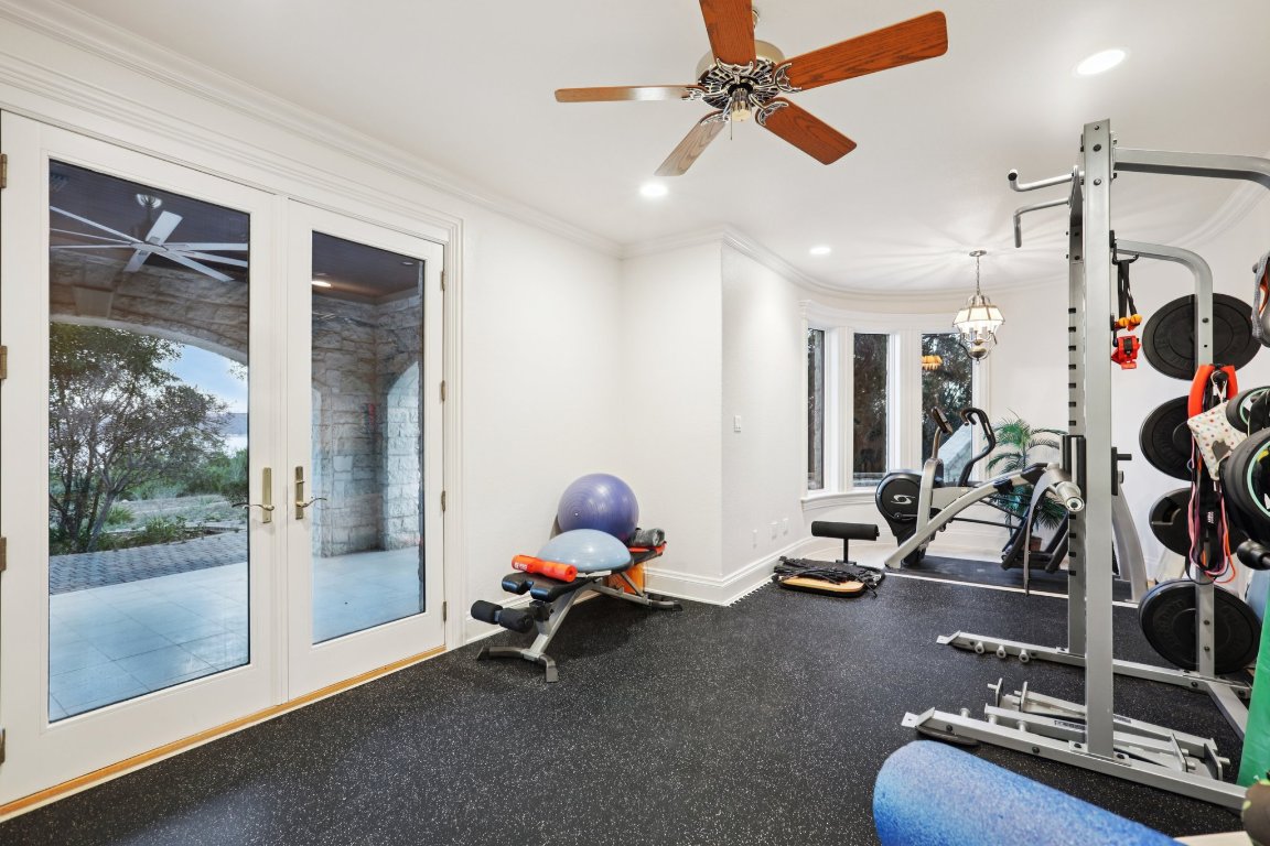 14701 Hornsby Hill Road Austin, TX 78734 - Photo 18 of 40 a room with gym equipment and glass door