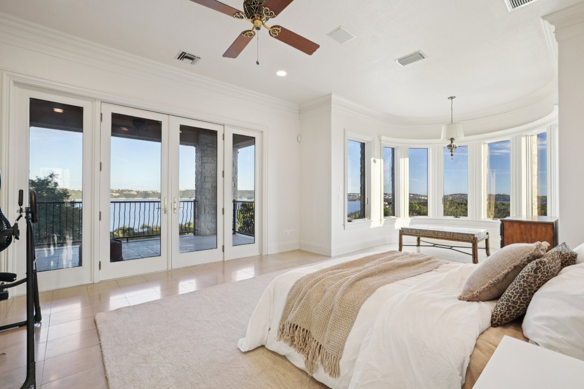 14701 Hornsby Hill Road Austin, TX 78734 - Photo 19 of 40 a spacious bedroom with a large bed and a large window