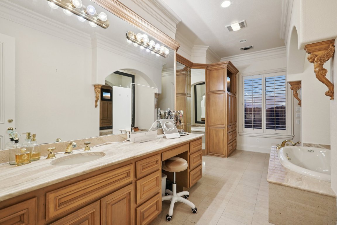 14701 Hornsby Hill Road Austin, TX 78734 - Photo 20 of 40 a spacious bathroom with a granite countertop sink mirror and a bathtub