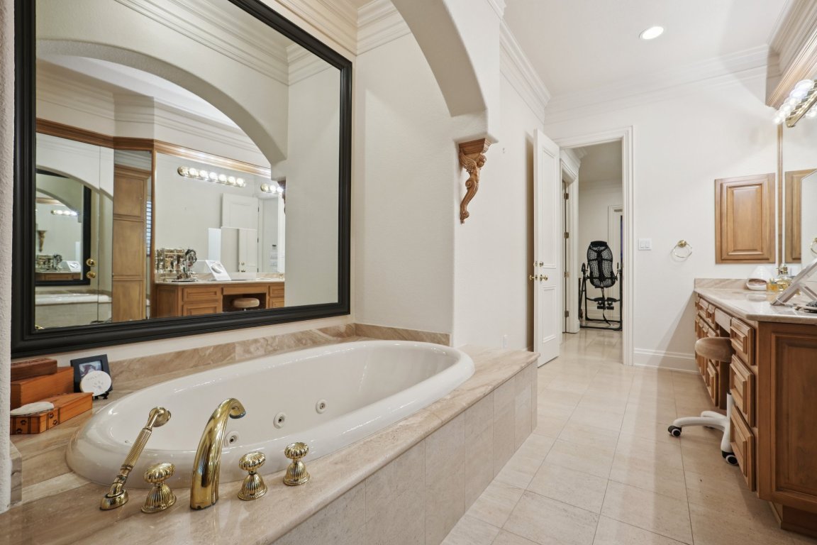 14701 Hornsby Hill Road Austin, TX 78734 - Photo 21 of 40 a bathroom with a tub a sink and a mirror