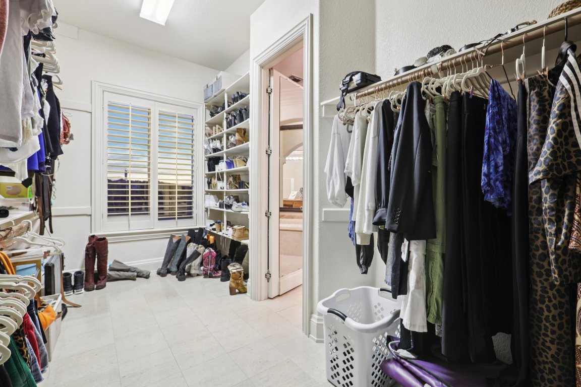 14701 Hornsby Hill Road Austin, TX 78734 - Photo 22 of 40 a view of walk in closet with clothes and shoes