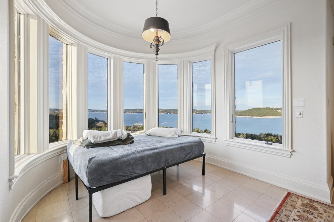 14701 Hornsby Hill Road Austin, TX 78734 - Photo 24 of 40 a bedroom with a bed and a large window with outer view