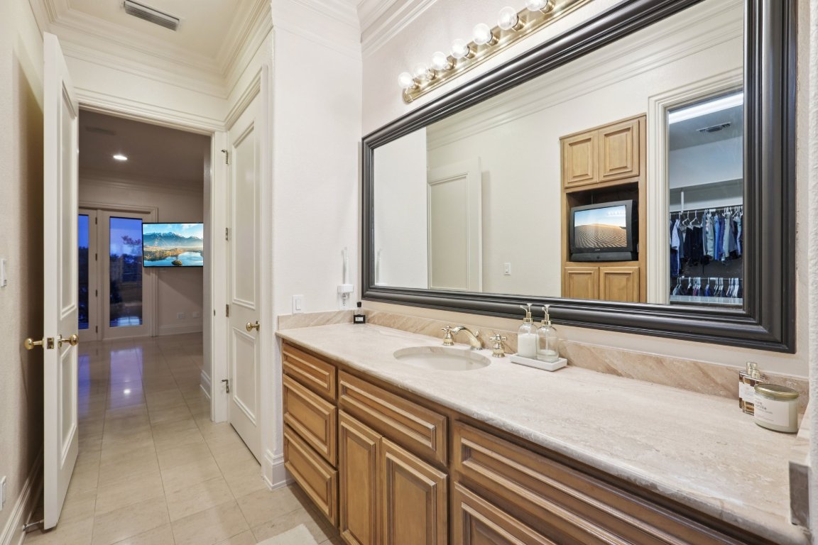 14701 Hornsby Hill Road Austin, TX 78734 - Photo 25 of 40 a bathroom with a sink and a mirror