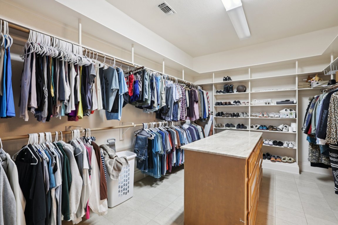14701 Hornsby Hill Road Austin, TX 78734 - Photo 28 of 40 a view of walk in closet with clothes