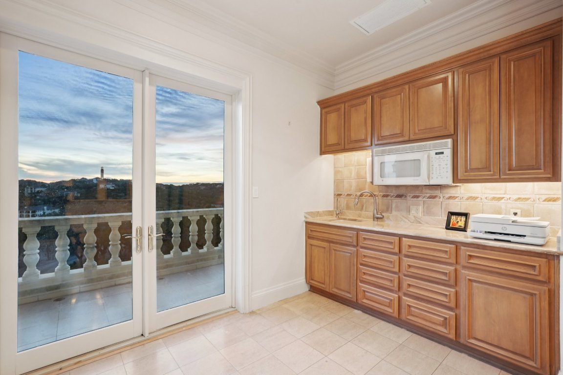 14701 Hornsby Hill Road Austin, TX 78734 - Photo 29 of 40 a kitchen with stainless steel appliances granite countertop a sink and cabinets